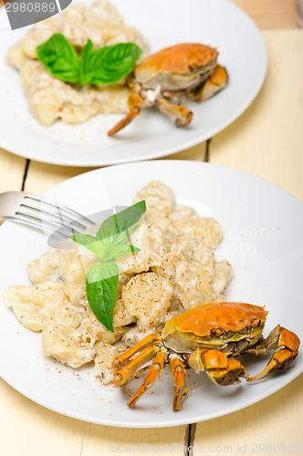 Image of Italian gnocchi with seafood sauce with crab and basil