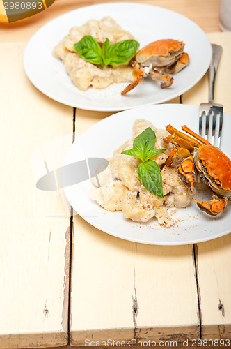 Image of Italian gnocchi with seafood sauce with crab and basil