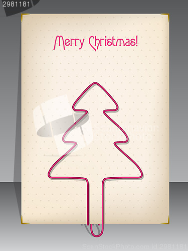 Image of Christmas greeting with christmas tree shaped paper clip