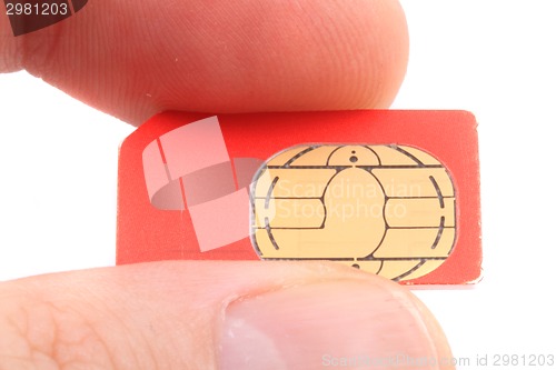 Image of cellphone cimcard in the human fingers 