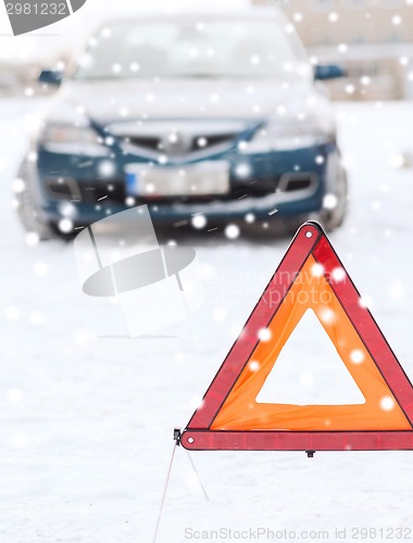 Image of closeup of warning triangle and car