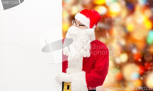 Image of man in costume of santa claus with billboard