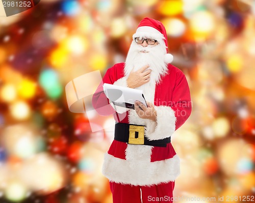 Image of man in costume of santa claus with notepad