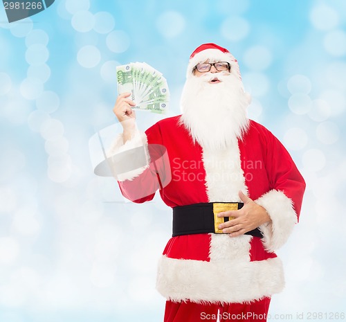 Image of man in costume of santa claus with euro money