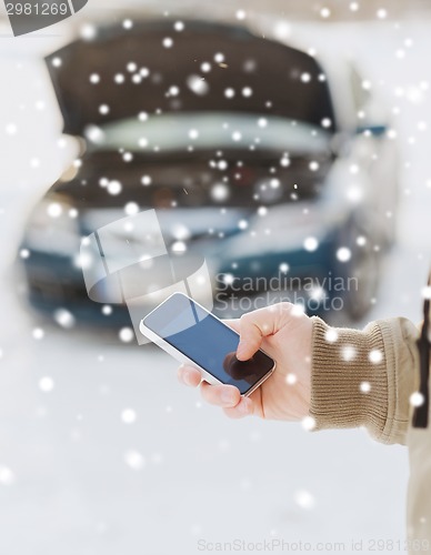 Image of closeup of man with broken car and smartphone