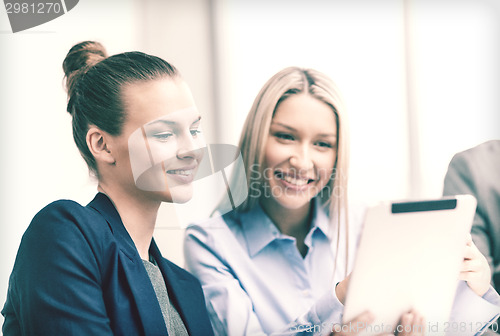 Image of business team with tablet pc having discussion
