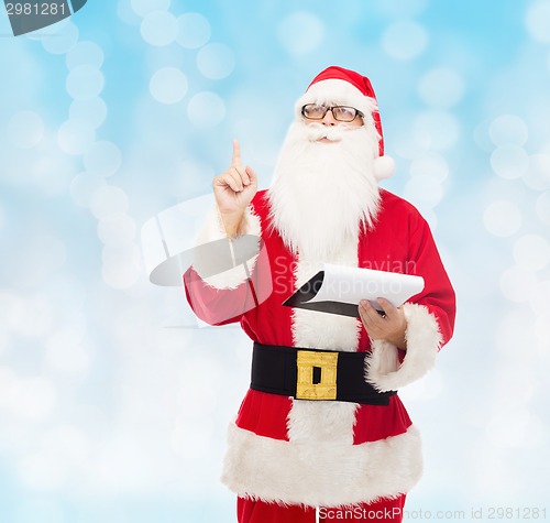 Image of man in costume of santa claus with notepad