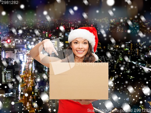 Image of smiling woman in santa helper hat with parcel box
