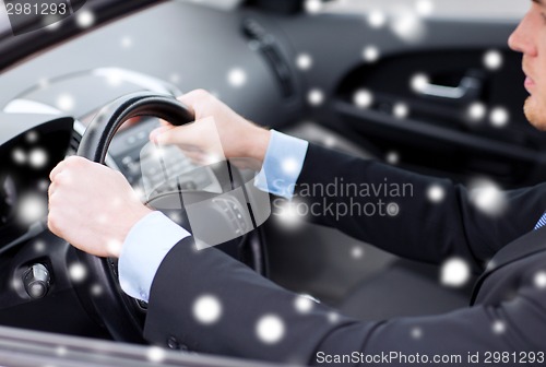 Image of close up of businessman driving car