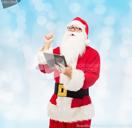 Image of man in costume of santa claus with tablet pc