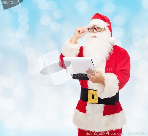 Image of man in costume of santa claus with notepad