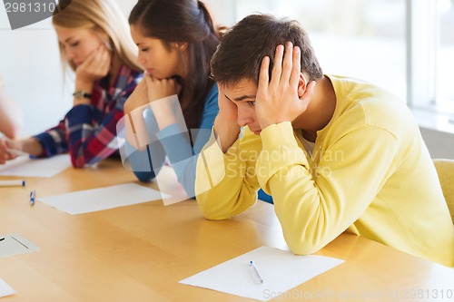 Image of group of students with papers