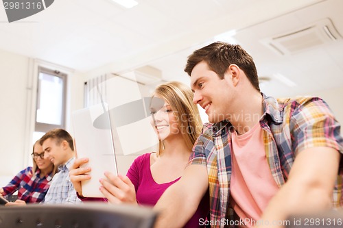 Image of group of smiling students with tablet pc
