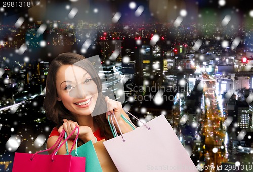 Image of smiling young woman with shopping bags