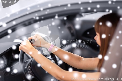 Image of close up of smiling businesswoman driving car