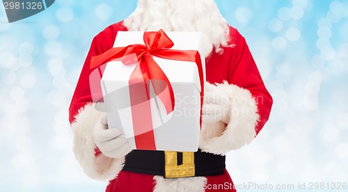 Image of man in costume of santa claus with gift box