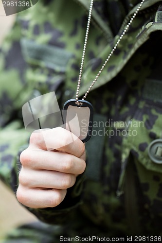 Image of close up of young soldier in military uniform