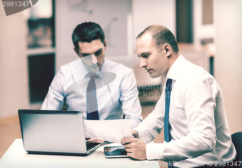 Image of two businessmen having discussion in office