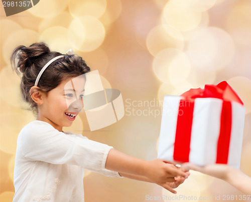 Image of smiling little girl with gift box