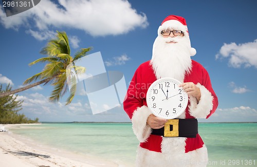 Image of man in costume of santa claus with clock