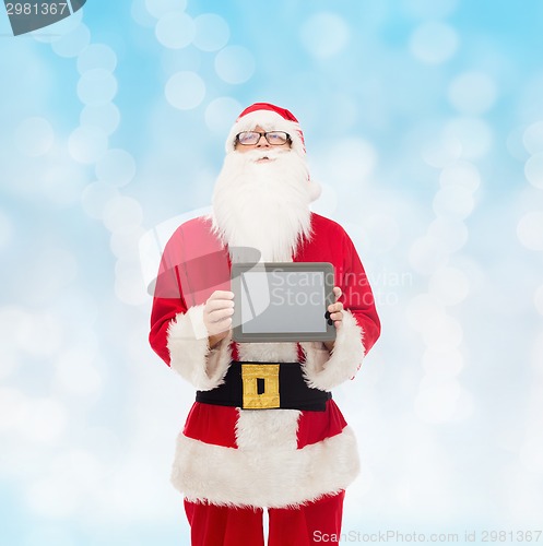 Image of man in costume of santa claus with tablet pc