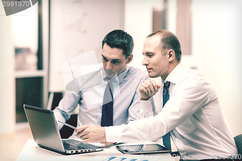 Image of two businessmen having discussion in office