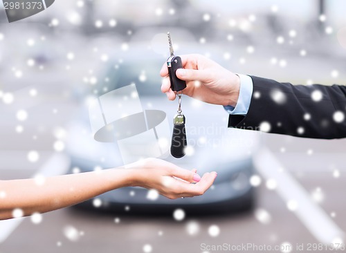 Image of close up of man with car key outdoors