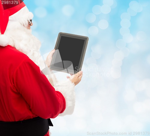 Image of man in costume of santa claus with tablet pc