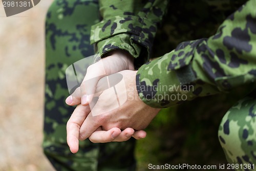 Image of close up of young soldier in military uniform