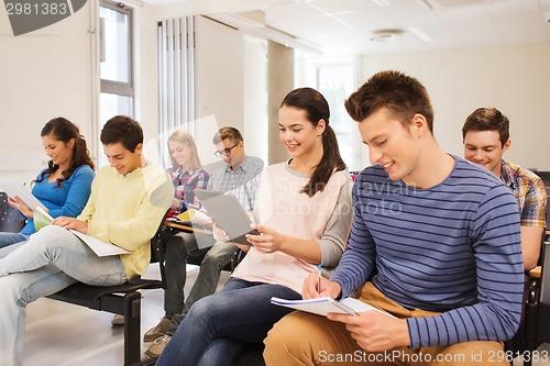 Image of group of smiling students with tablet pc