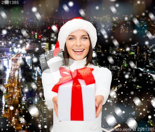 Image of smiling woman in santa helper hat with gift box