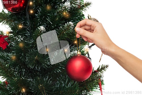 Image of close up of woman with christmas tree decoration