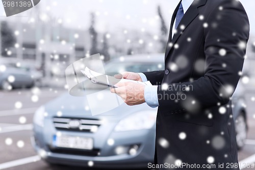 Image of close up of man with clipboard and car documents