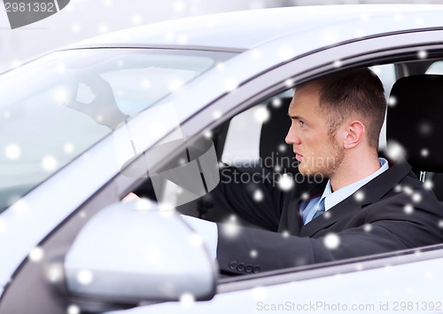 Image of close up of businessman driving car