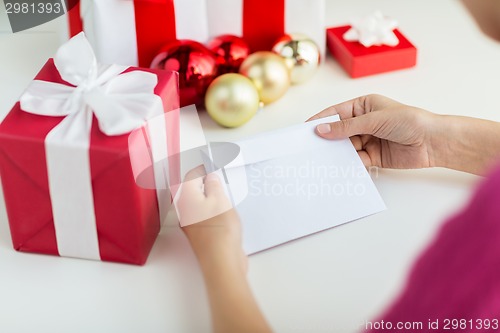 Image of close up of woman with letter and presents