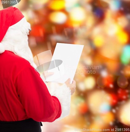 Image of man in costume of santa claus with letter