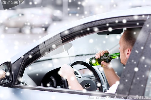 Image of close up of man drinking alcohol while driving car