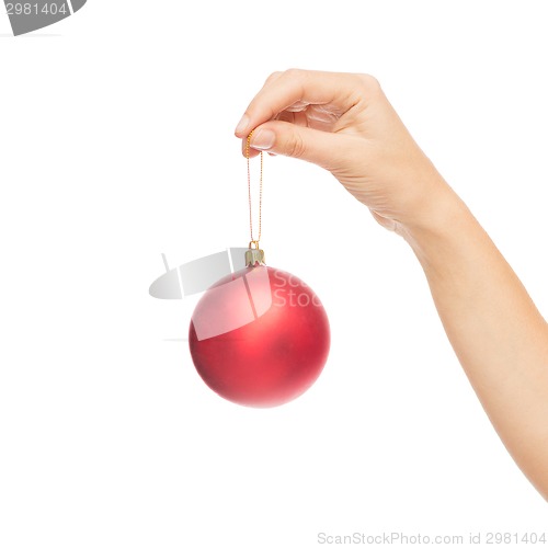 Image of close up of woman in sweater with christmas ball