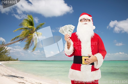 Image of man in costume of santa claus with dollar money