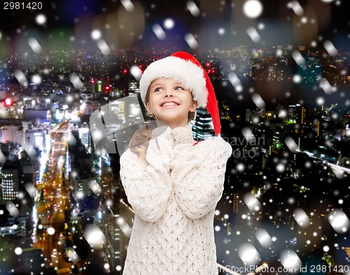 Image of dreaming girl in santa helper hat