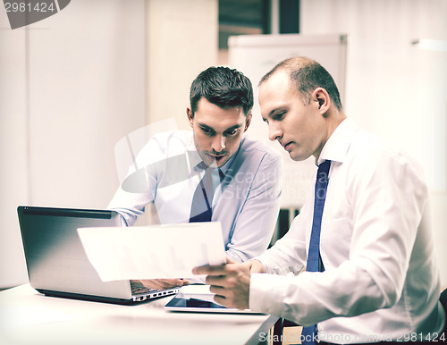 Image of two businessmen having discussion in office