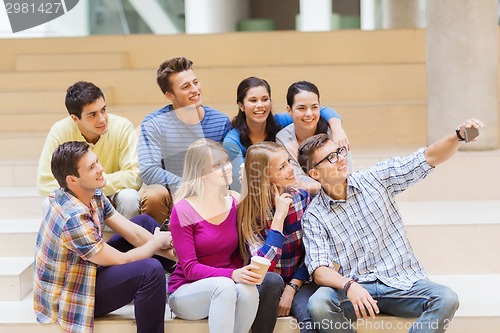 Image of group of students with smartphone and coffee cup