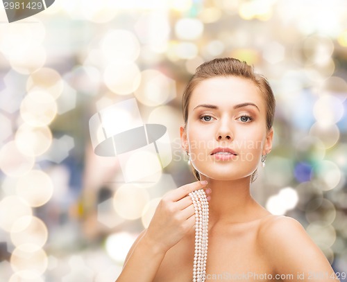 Image of beautiful woman with pearl earrings and bracelet