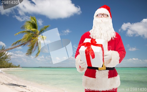 Image of man in costume of santa claus with gift box