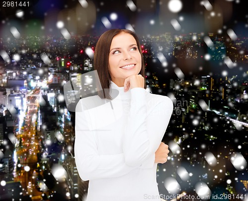Image of smiling young woman in winter clothes