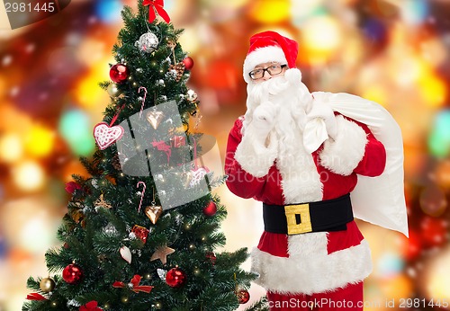 Image of santa claus with bag and christmas tree