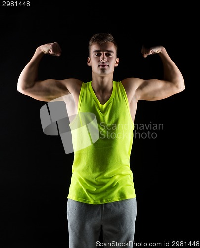 Image of young man showing biceps