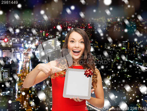 Image of smiling woman in red dress with tablet pc