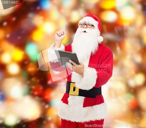 Image of man in costume of santa claus with tablet pc
