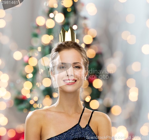 Image of smiling woman in evening dress wearing crown